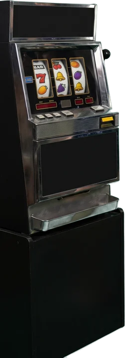 Woman holding a coin next to a slot machine