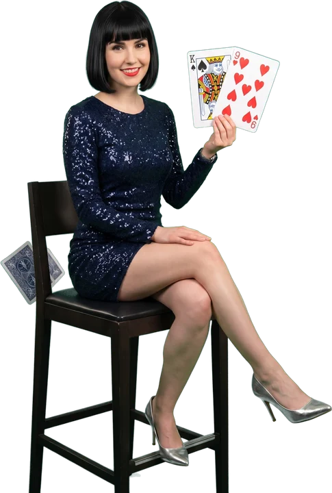 Woman holding a king and a nine among floating playing cards